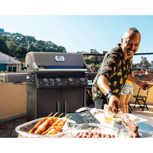 Napoleon Rogue gas grill being used for outdoor cooking with continuous fuel.
