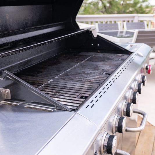 Stainless steel gas BBQ grill setup on an outdoor deck for Canadian summer grilling.