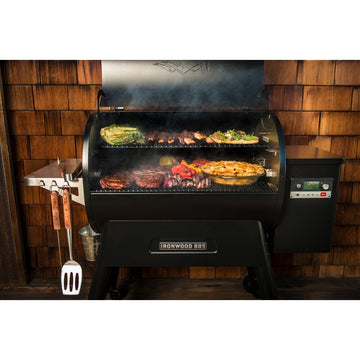 Close-up of food smoking on a Traeger Ironwood 885 wood-fired pellet grill grates.