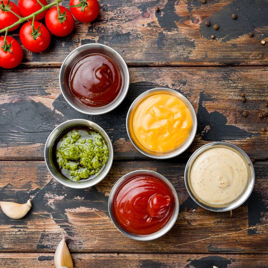 assorted sauces top view on old dark wooden table
