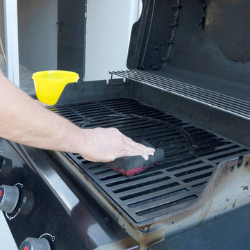 Cleaning the outdoor gas grill.